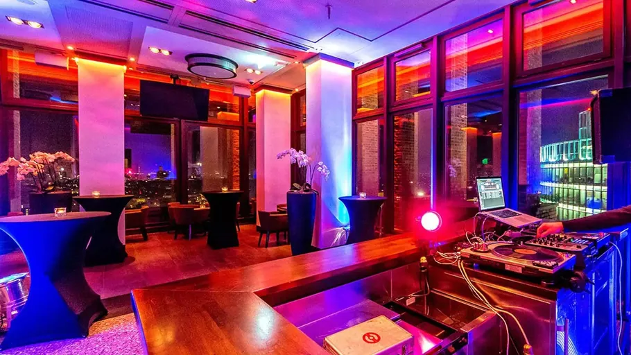 DJ booth in colorful rooftop lounge.
