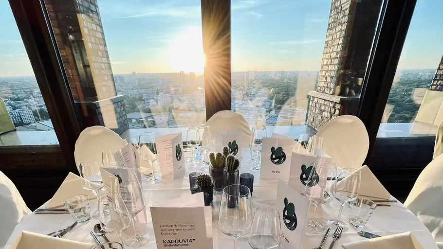 Elegant table set with city sunset view.