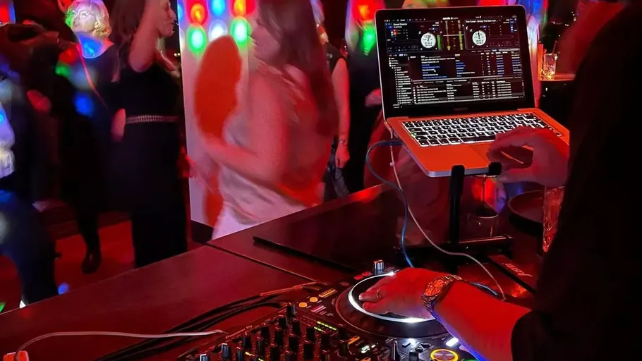 DJ performing at lively dance party.