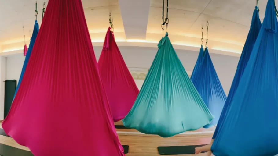 Colorful hammocks hanging in a room.