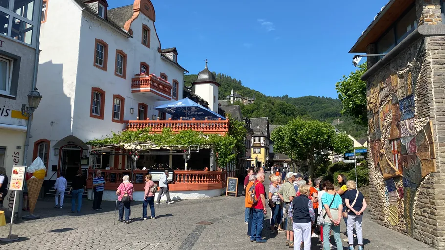 Tourists in a charming European town square.