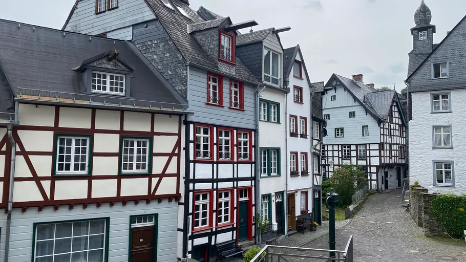 Half-timbered houses on cobblestone street.