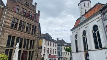Historic buildings and church in European town.