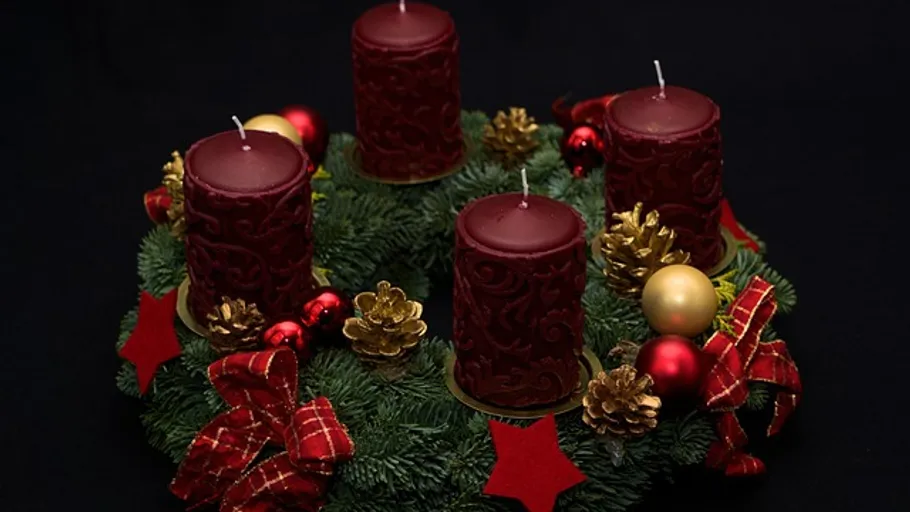 Four red candles on festive wreath.