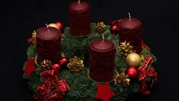 Four red candles on festive wreath.