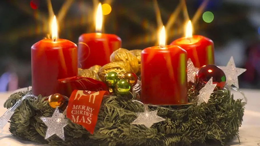 Four red candles on a decorated wreath.