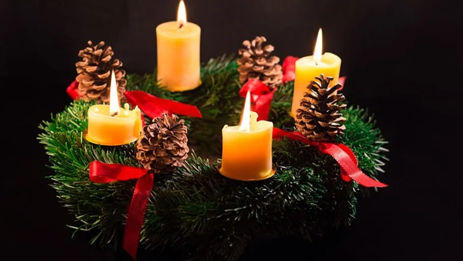 Candles and pinecones on an Advent wreath.